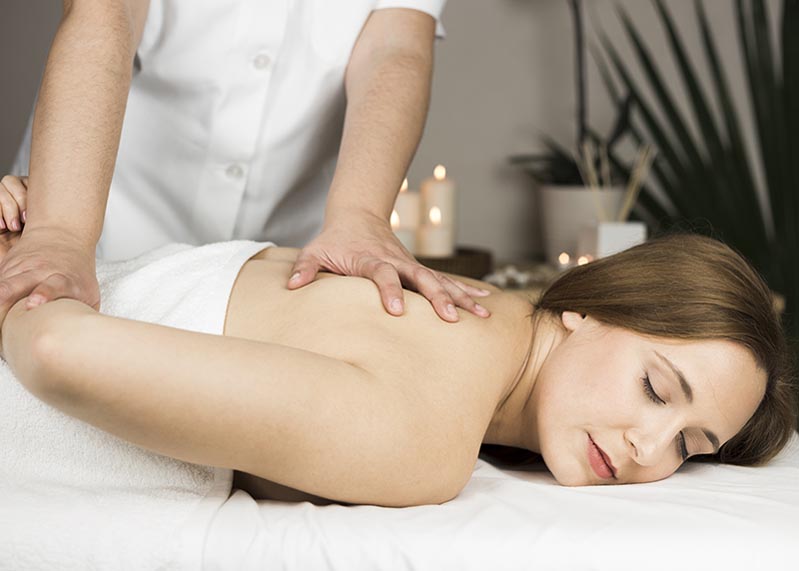 woman-receiving-massage-spa-center